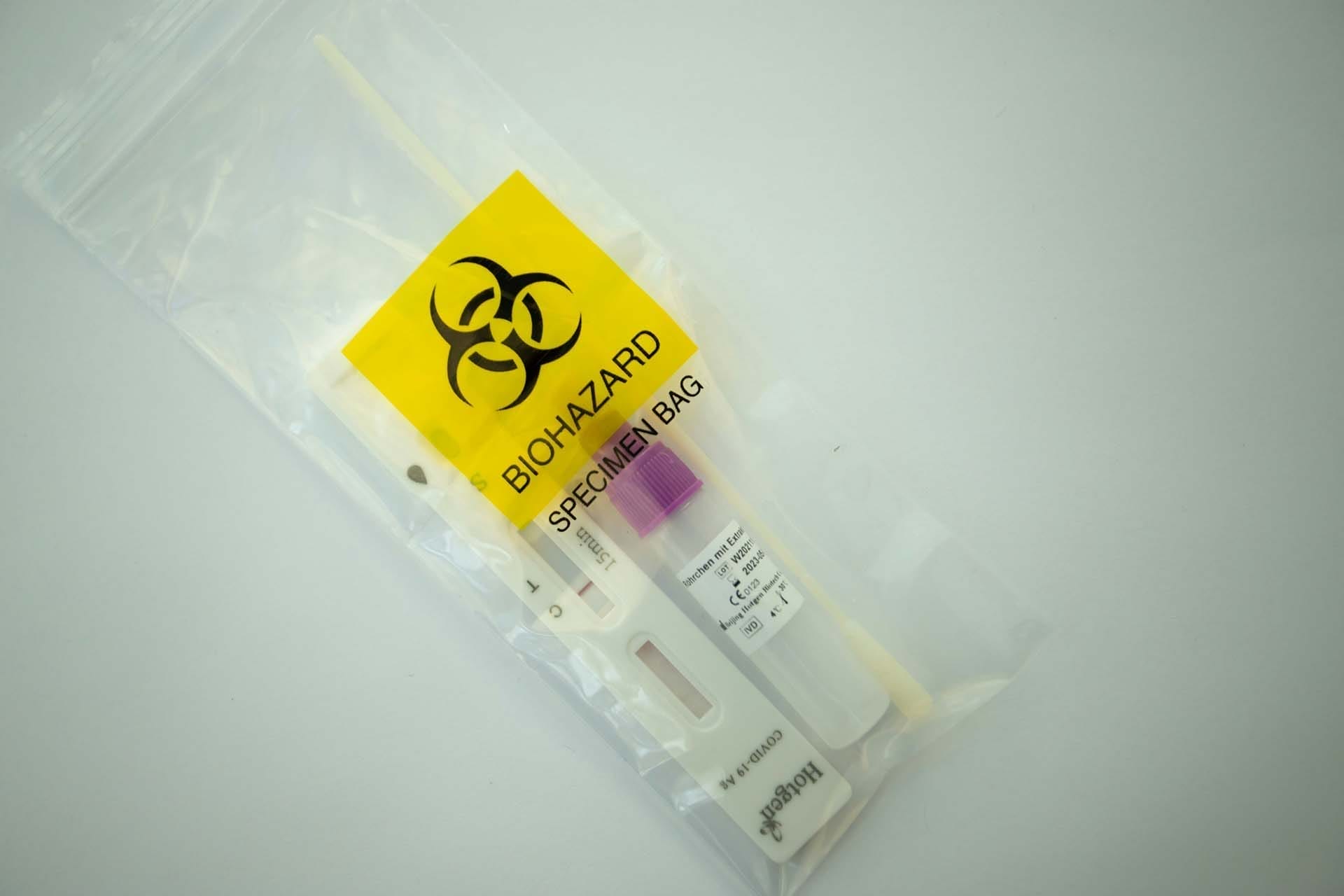 Biohazard specimen bag with test kit inside.