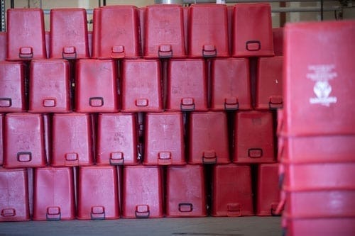 Stacked red plastic bins in warehouse