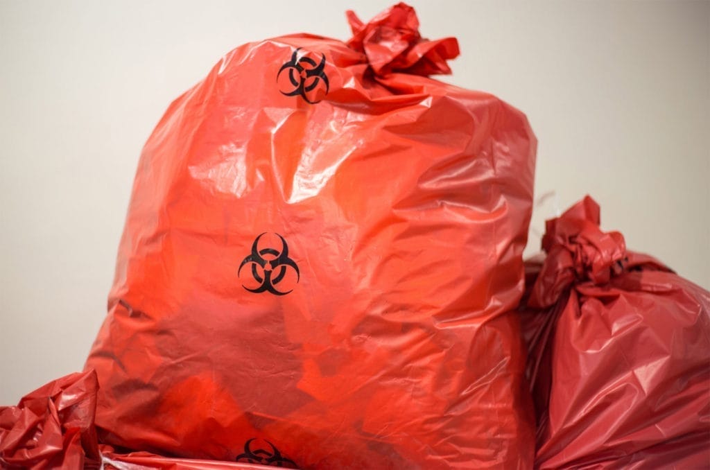 Red biohazard bags for medical waste disposal.