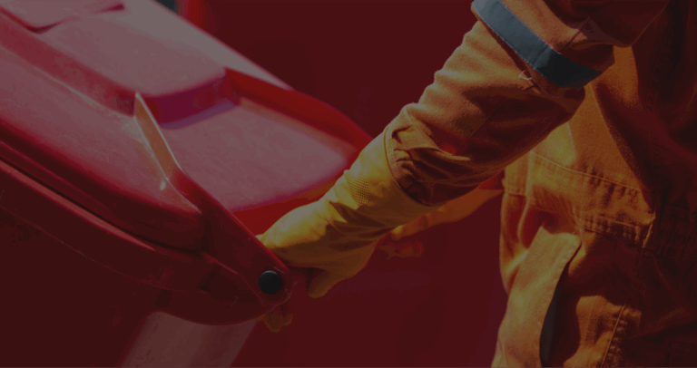 Person handling a red waste bin safely