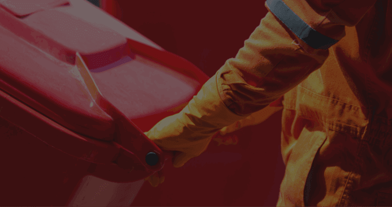 Person handling a red waste bin safely