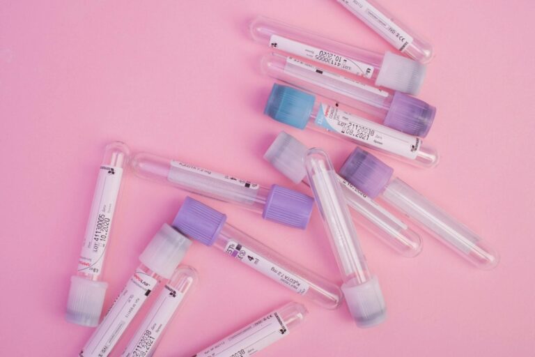 Empty blood test tubes on pink background