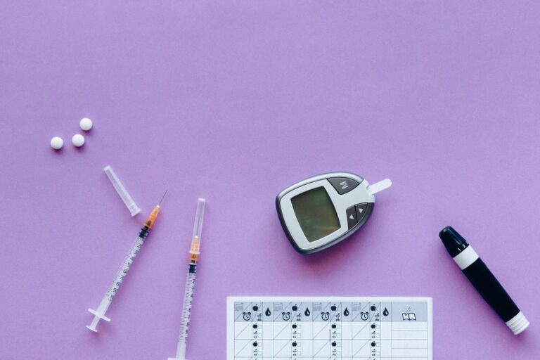 Diabetes management tools on purple surface