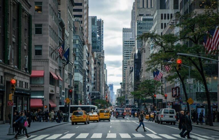 Busy New York street with taxis and skyscrapers.