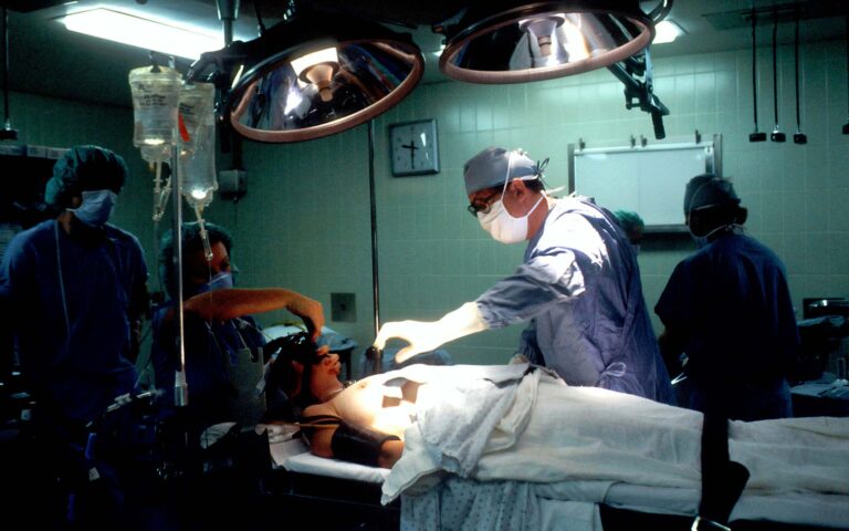 Surgeons operating in a hospital operating room.