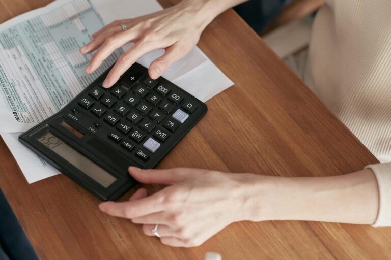 Person using calculator on tax document